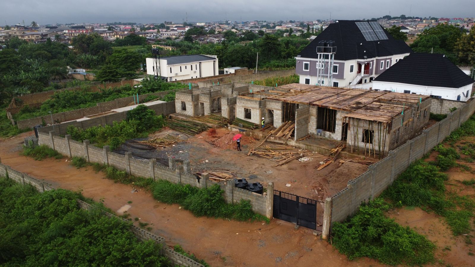 Aerial view of the Eden site at weeks 11 and 12: timber decking on bamboo props spanning the two-storey block, ready for the first-floor slab