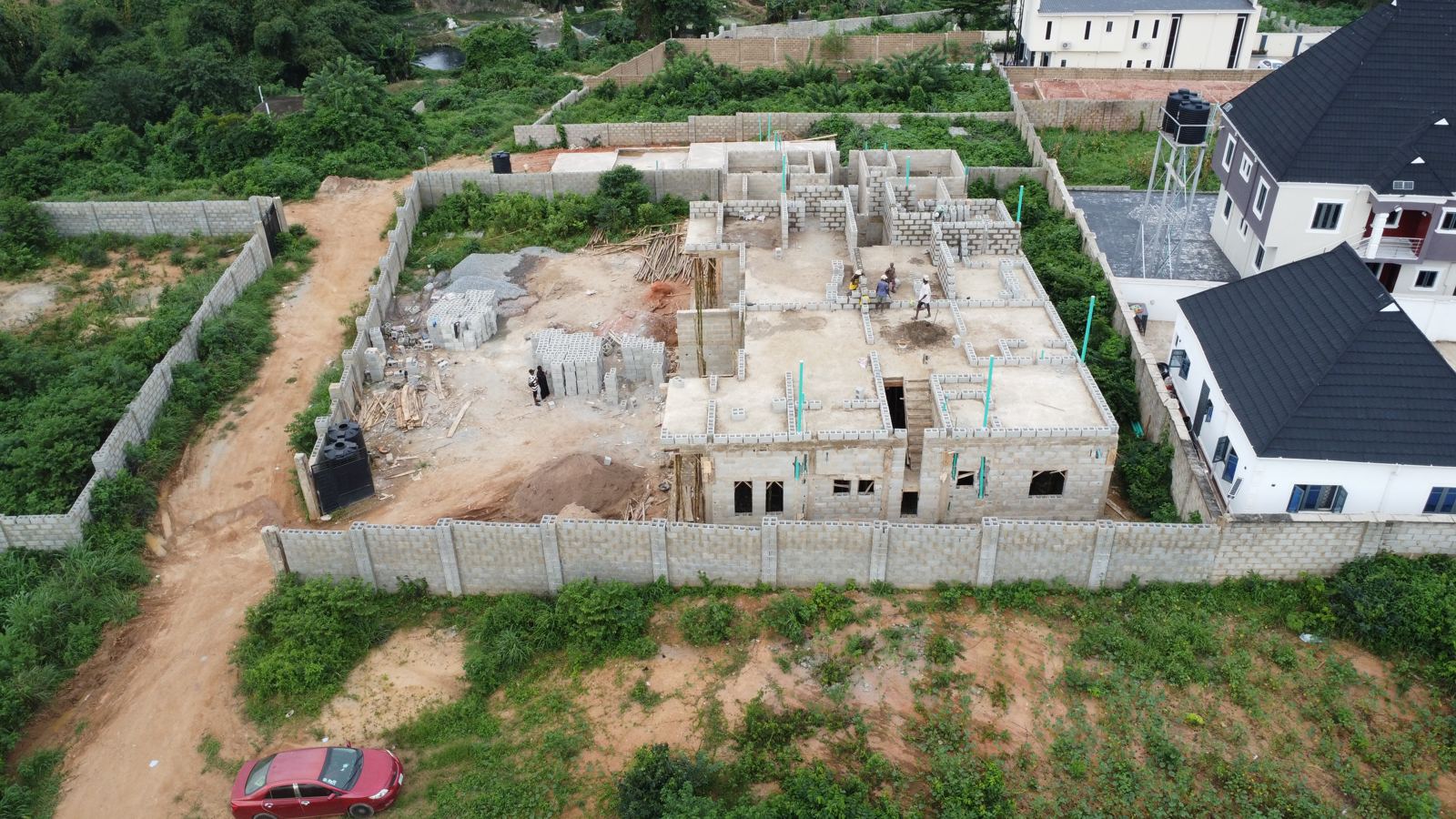 Aerial view of the Eden site at weeks 13 and 14: the first-floor concrete slab cast on the two-storey block with upper-floor blockwork starting