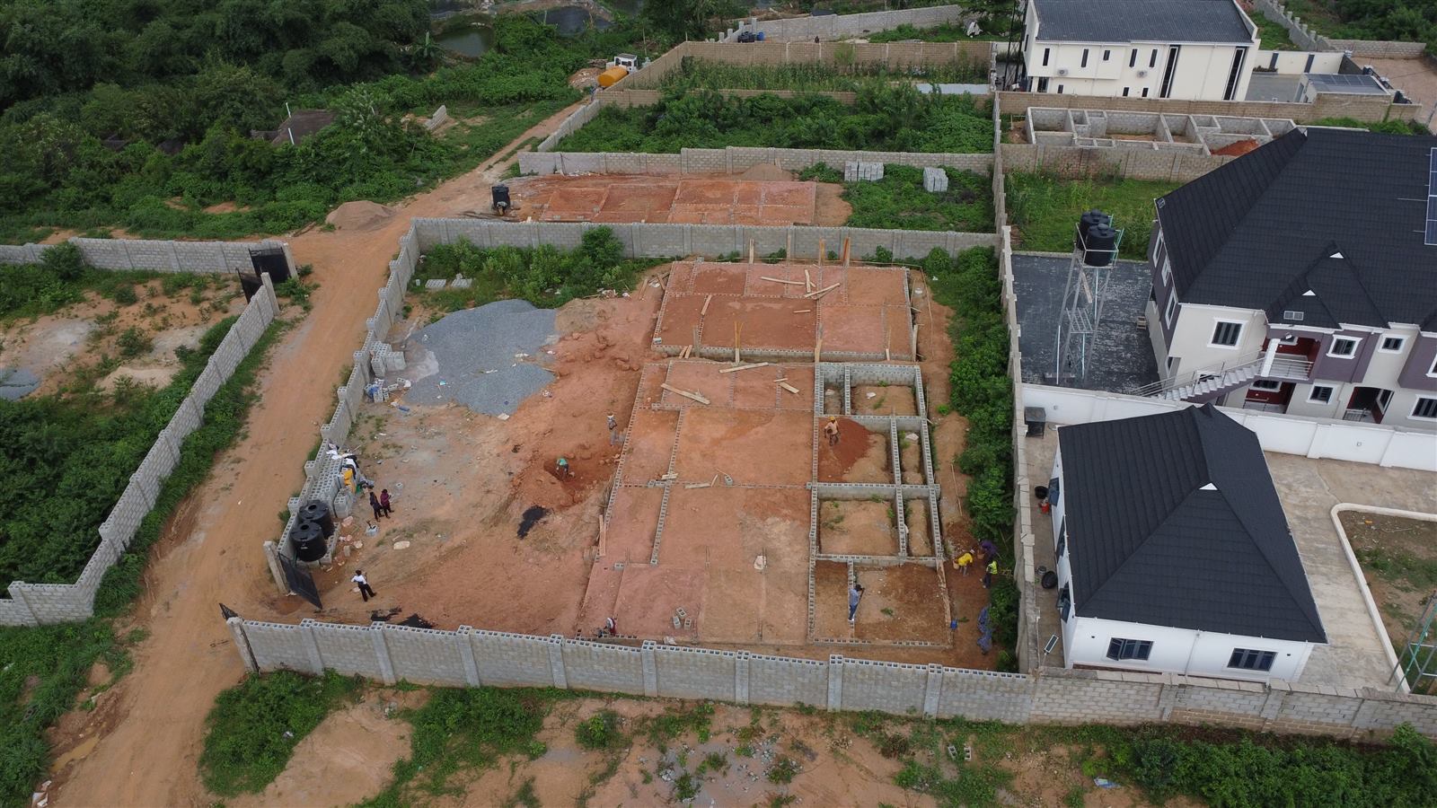 Aerial view of the Eden site at weeks 5 and 6: all three foundations backfilled with laterite and compacted
